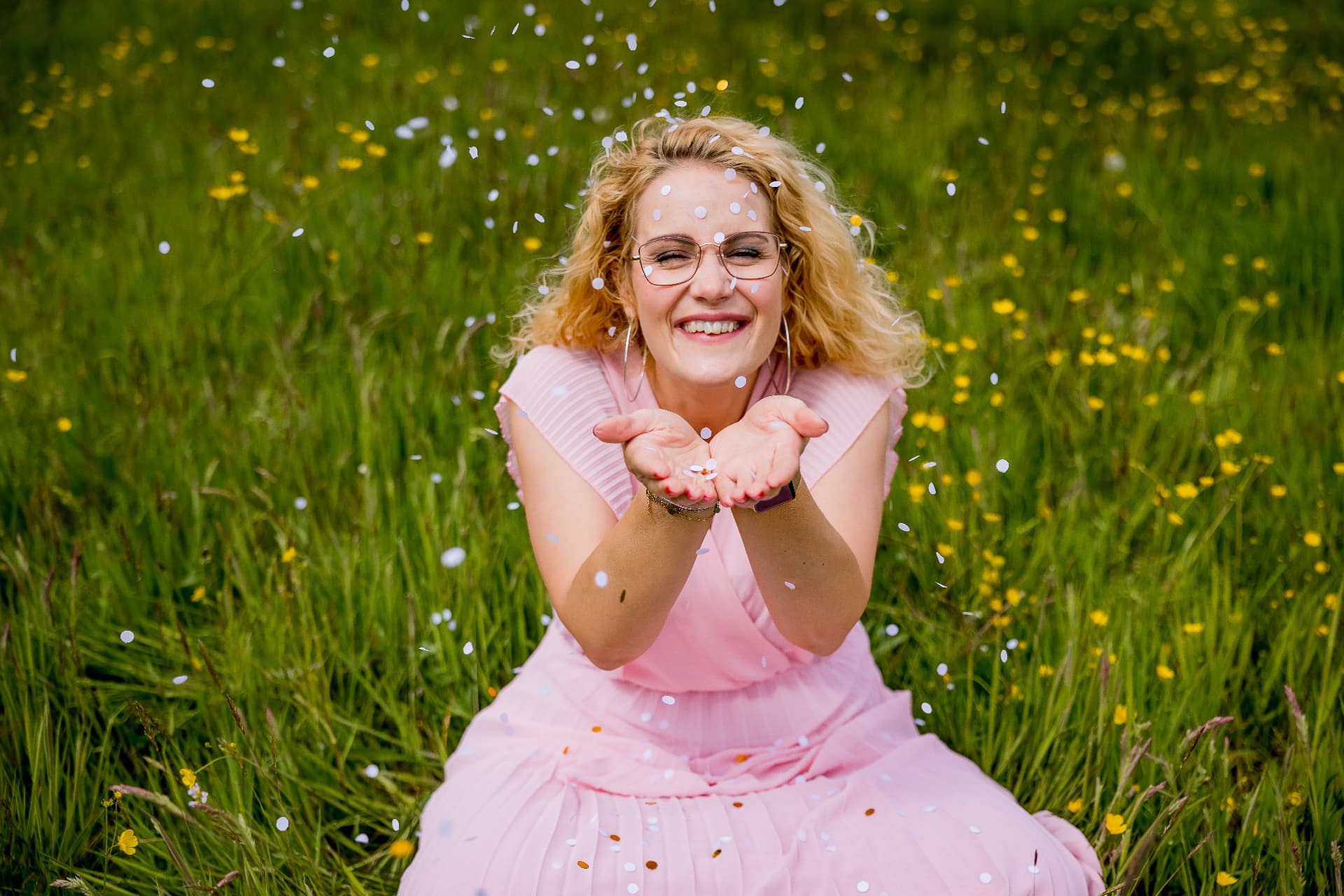 Miranda blaast confetti in een bloemenveld